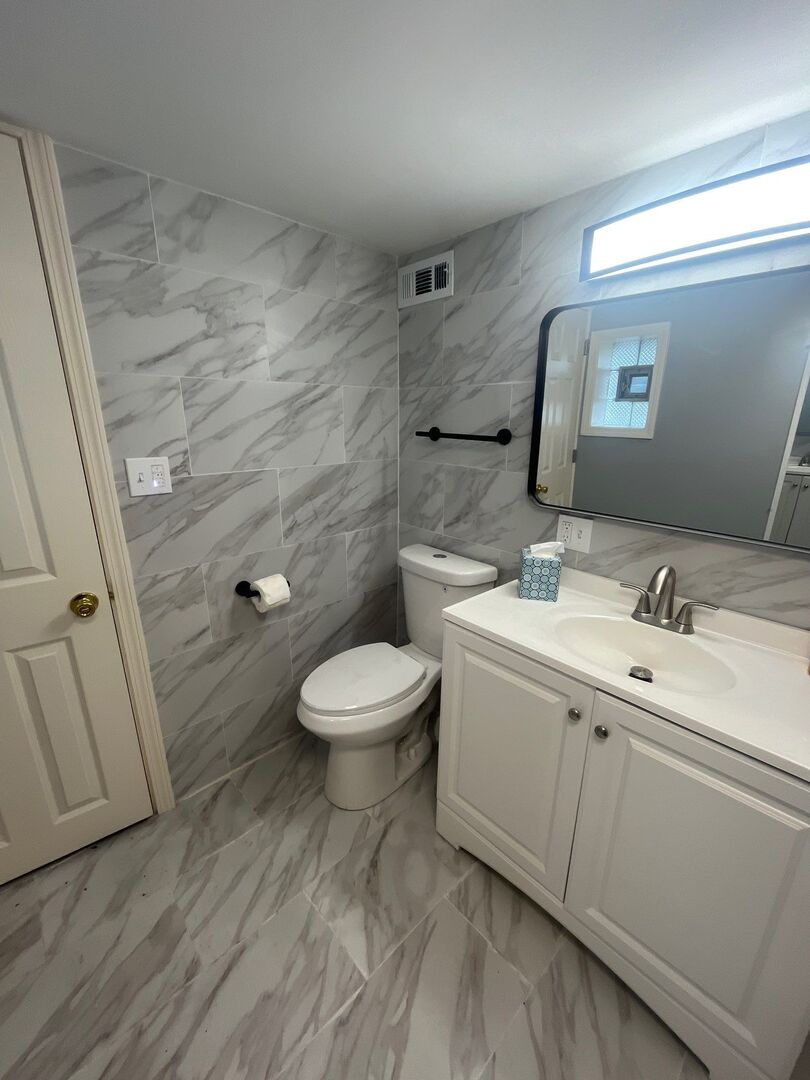 7438 South Champlain Avenue Chicago, IL 60619 - Photo 40 of 41 a bathroom with a toilet sink and mirror