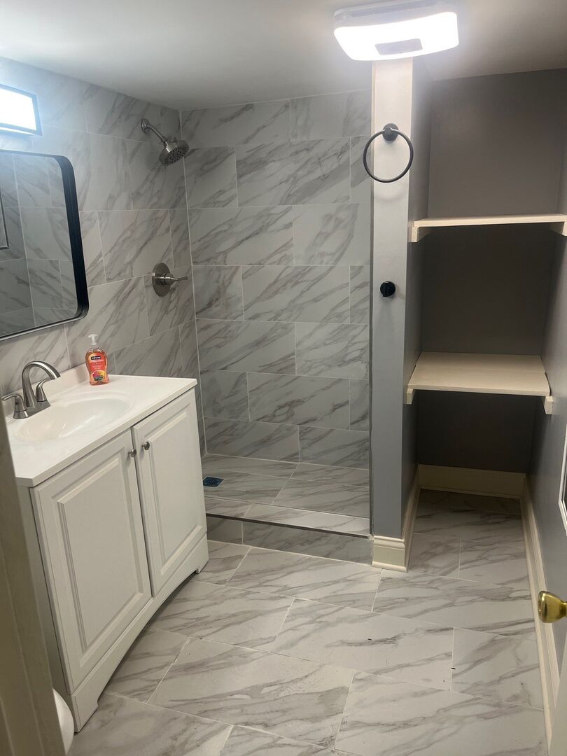 7438 South Champlain Avenue Chicago, IL 60619 - Photo 41 of 41 a bathroom with a sink a toilet and shower
