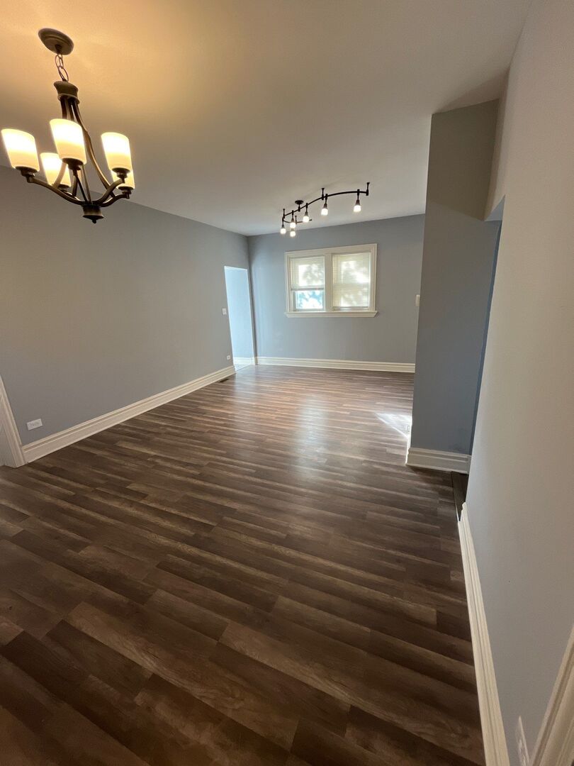 7438 South Champlain Avenue Chicago, IL 60619 - Photo 10 of 41 a view of a livingroom with wooden floor