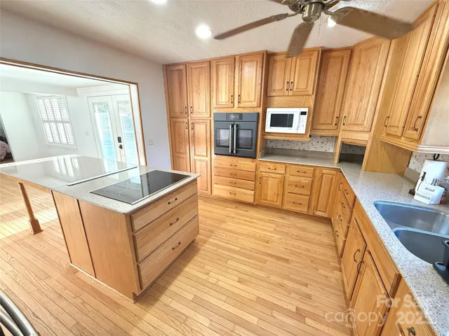 a kitchen with wooden cabinets and sink