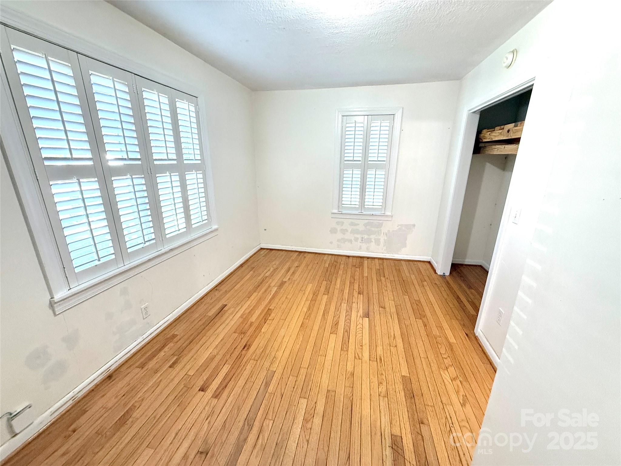 718 Bald Mountain Road Burnsville, NC 28714 - Photo 16 of 37 a view of a room with wooden floor and staircase