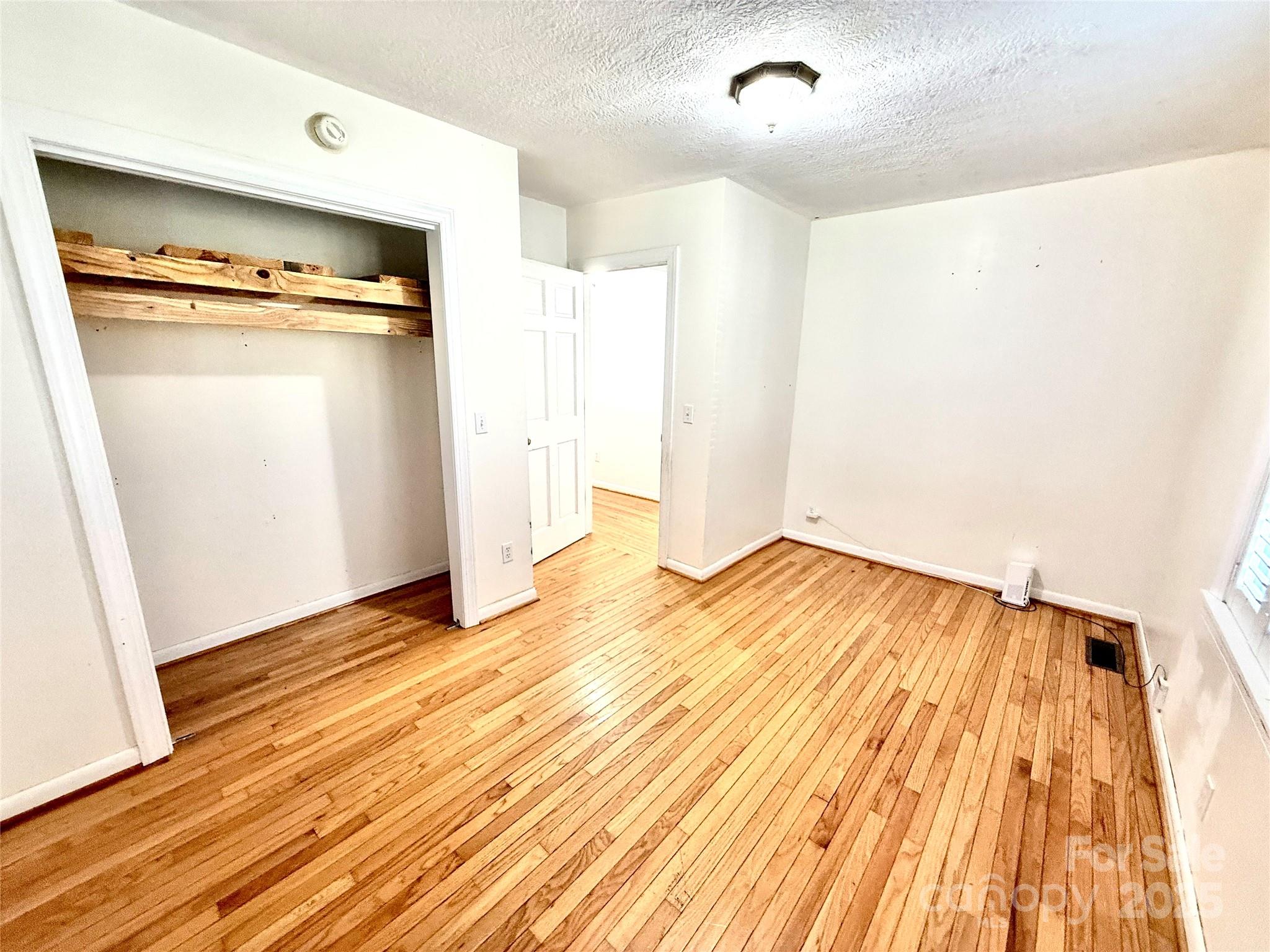 718 Bald Mountain Road Burnsville, NC 28714 - Photo 17 of 37 a view of an empty room with wooden floor