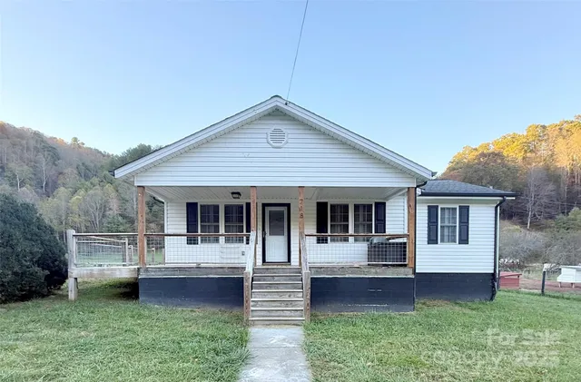 a front view of house with yard and outdoor seating