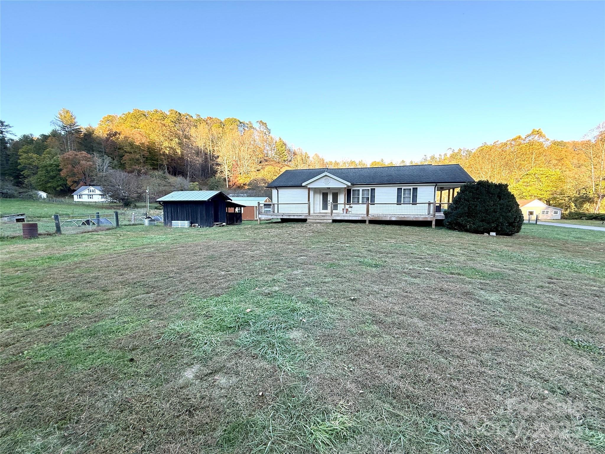 718 Bald Mountain Road Burnsville, NC 28714 - Photo 21 of 37 a view of a house with a yard and sitting area
