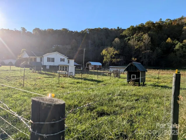 a view of a house with a yard and sitting area