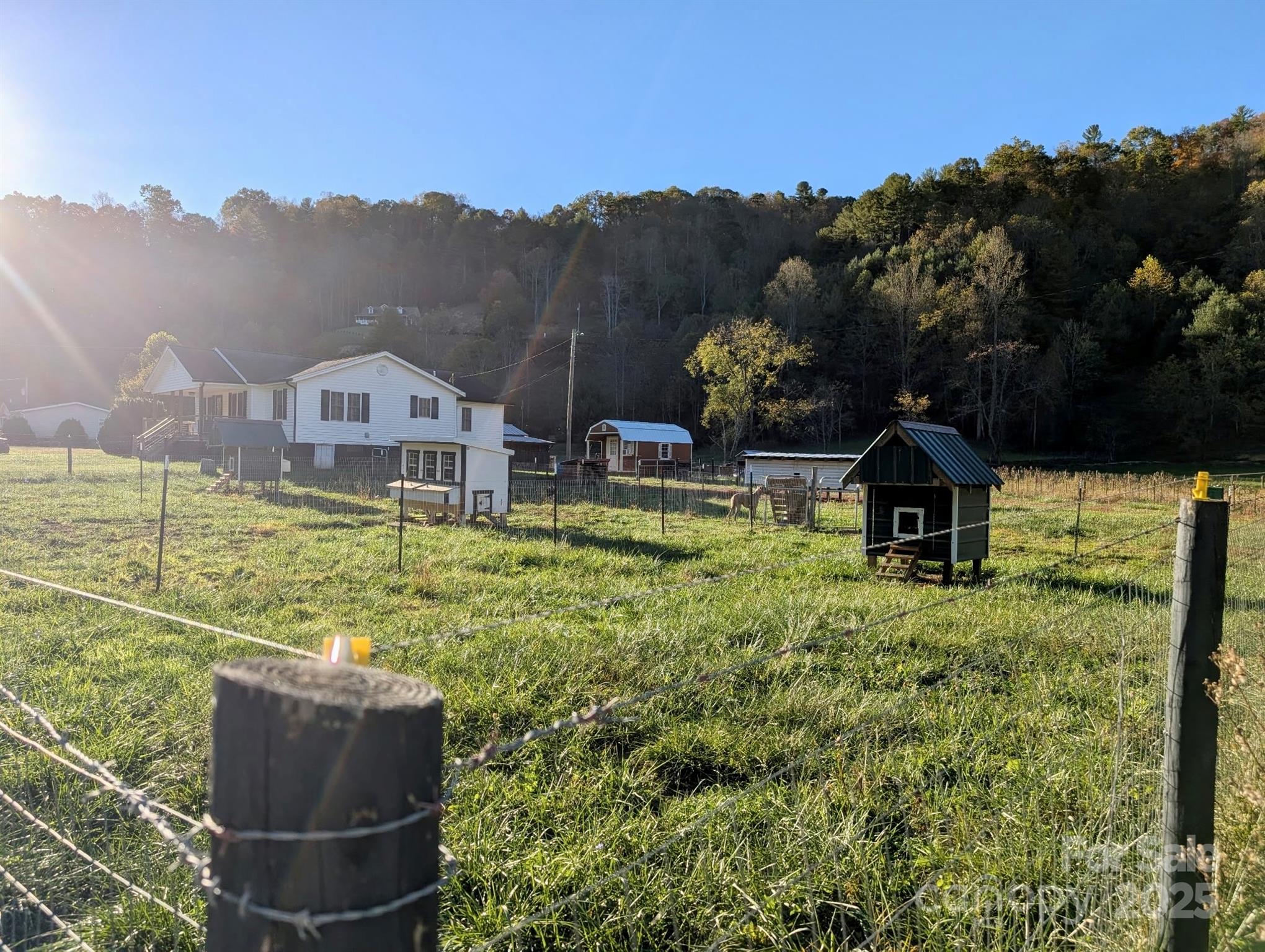 718 Bald Mountain Road Burnsville, NC 28714 - Photo 23 of 37 a view of a house with a yard and sitting area