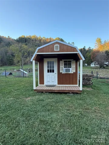 a view of a barn with big yard