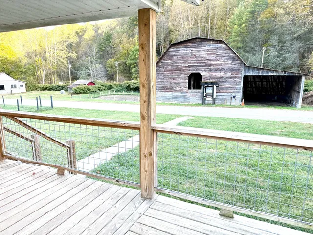 a view of a balcony with floor to ceiling windows and a yard
