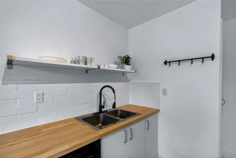 a kitchen with a sink and cabinets
