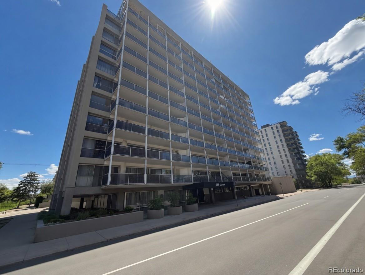 888 Logan Street, Unit 5H Denver, CO 80203 - Photo 1 of 25 a view of a tall building next to a yard