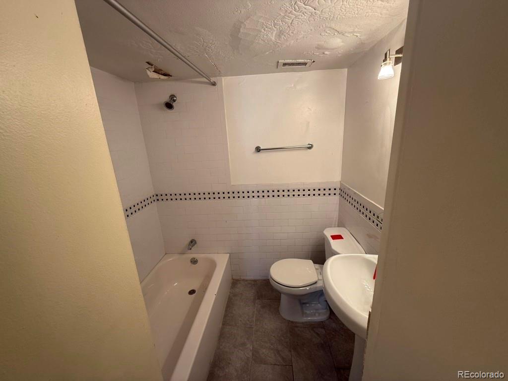 888 Logan Street, Unit 5H Denver, CO 80203 - Photo 15 of 25 a bathroom with a toilet sink and shower