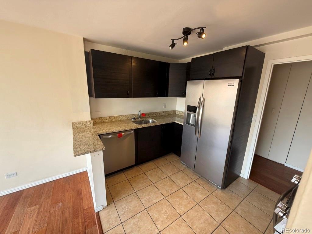 888 Logan Street, Unit 5H Denver, CO 80203 - Photo 6 of 25 a kitchen with stainless steel appliances a refrigerator and a stove