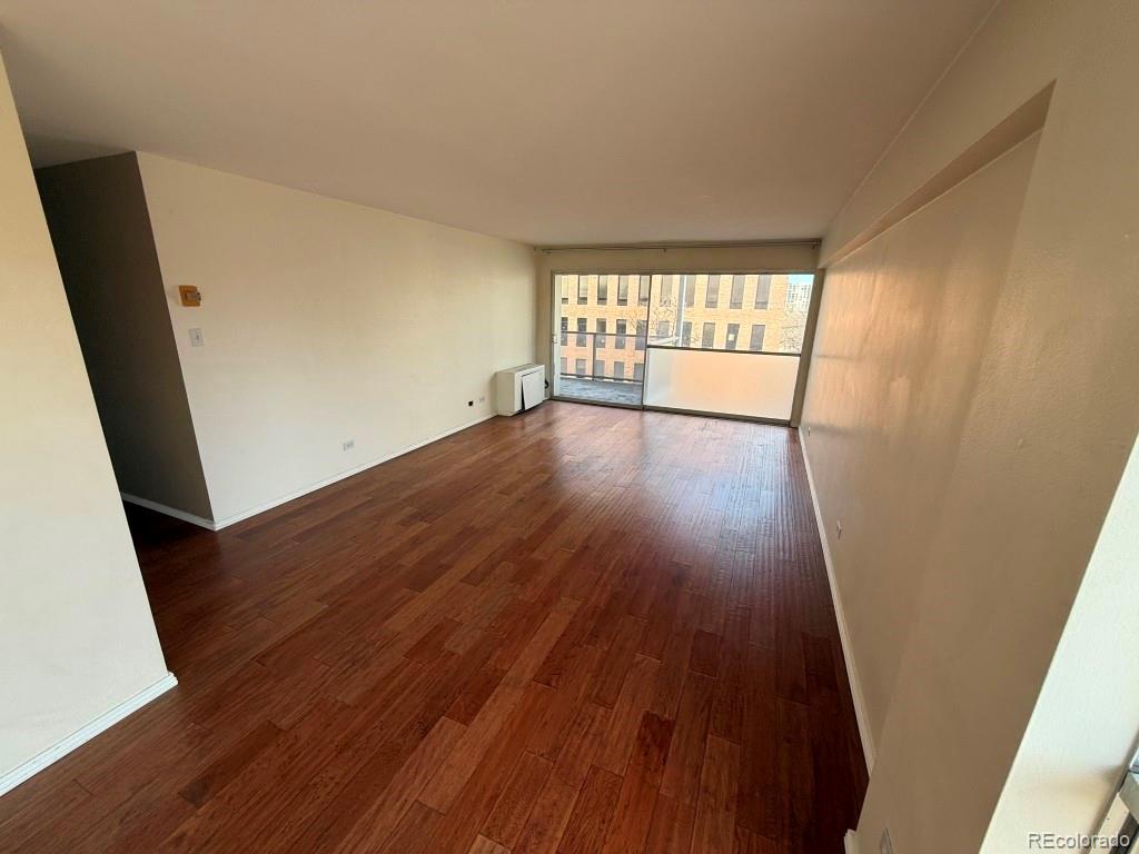 888 Logan Street, Unit 5H Denver, CO 80203 - Photo 8 of 25 wooden floor in an empty room with a window