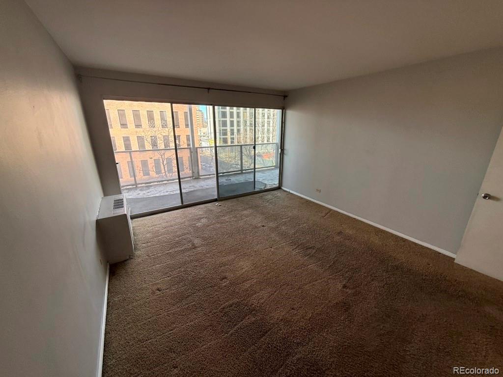 888 Logan Street, Unit 5H Denver, CO 80203 - Photo 10 of 25 a view of an empty room with a window