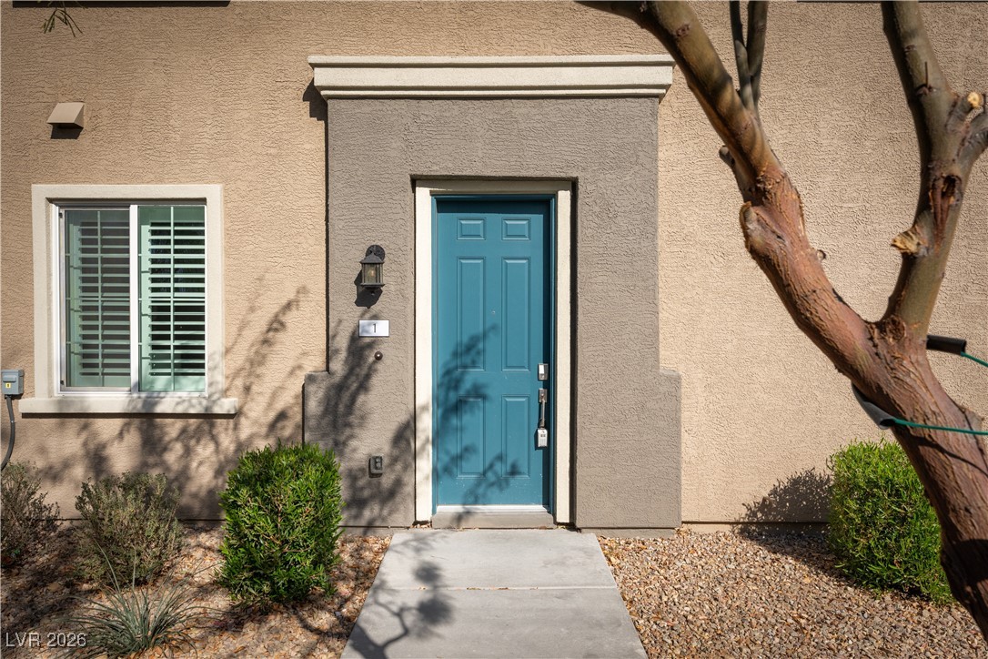 View of exterior entry with stucco siding
