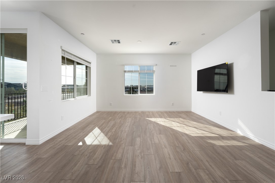 7330 North Decatur Boulevard, Unit 1 North Las Vegas, NV 89084 - Photo 13 of 29 Empty room with wood finished floors and baseboards
