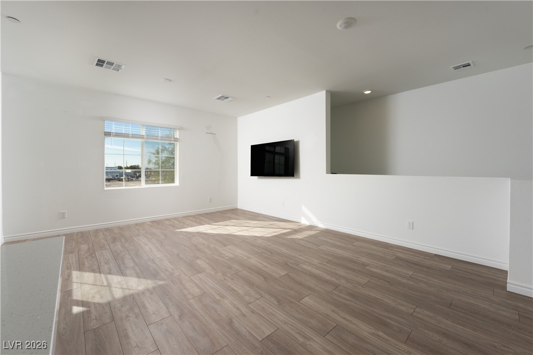 7330 North Decatur Boulevard, Unit 1 North Las Vegas, NV 89084 - Photo 14 of 29 Spare room with wood finished floors and recessed lighting