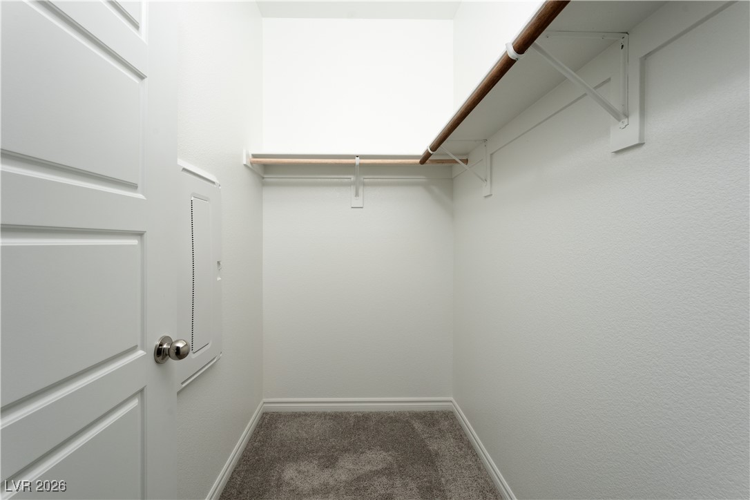 7330 North Decatur Boulevard, Unit 1 North Las Vegas, NV 89084 - Photo 17 of 29 Walk in closet with dark colored carpet