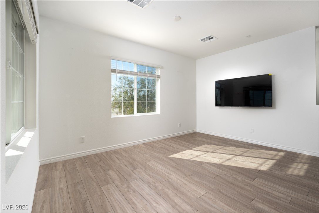7330 North Decatur Boulevard, Unit 1 North Las Vegas, NV 89084 - Photo 18 of 29 Spare room featuring wood finished floors and baseboards