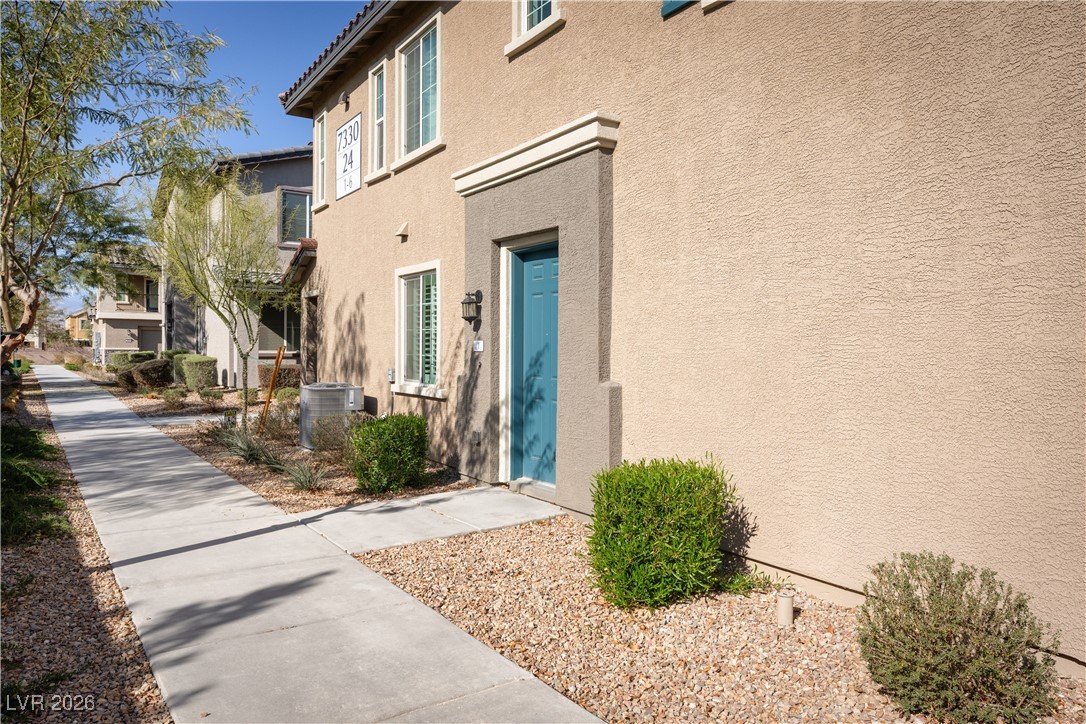 7330 North Decatur Boulevard, Unit 1 North Las Vegas, NV 89084 - Photo 2 of 29 Entrance to property featuring stucco siding and a tile roof
