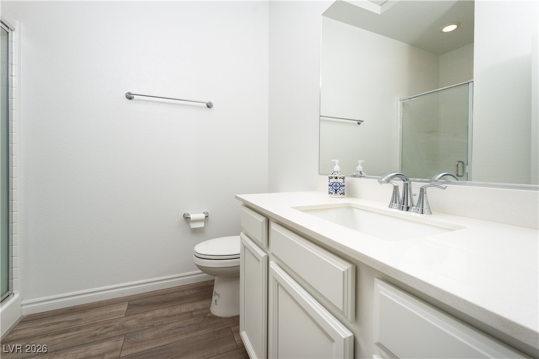 7330 North Decatur Boulevard, Unit 1 North Las Vegas, NV 89084 - Photo 21 of 29 Bathroom with a stall shower, vanity, and dark wood-style floors
