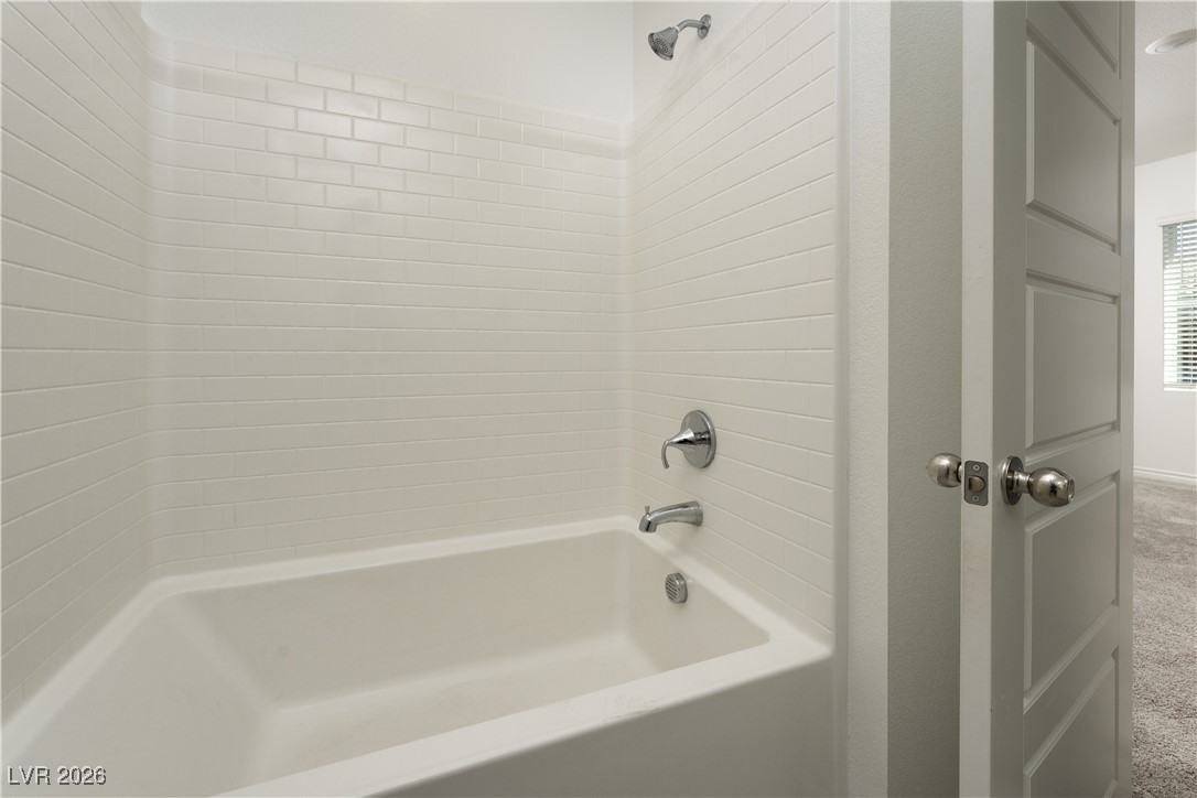 7330 North Decatur Boulevard, Unit 1 North Las Vegas, NV 89084 - Photo 25 of 29 Bathroom with shower / bath combination and carpet flooring