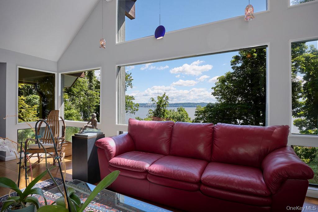 273 River Road Nyack, NY 10960 - Photo 3 of 48 Interior space featuring vaulted ceilings, expansive windows, wood-finish flooring, and pendant lighting