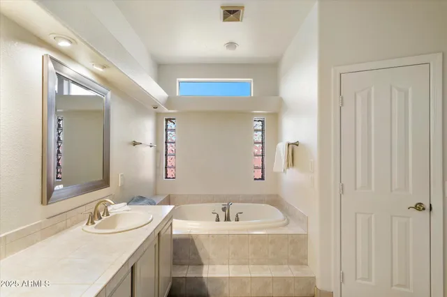 a bathroom with a granite countertop sink mirror and