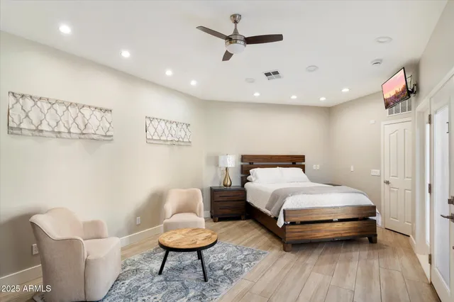 a bedroom with a bed and a large mirror