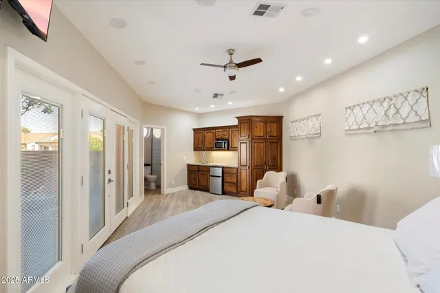 a bathroom with a granite countertop toilet sink and mirror