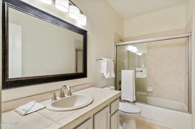 a room with pool table and windows