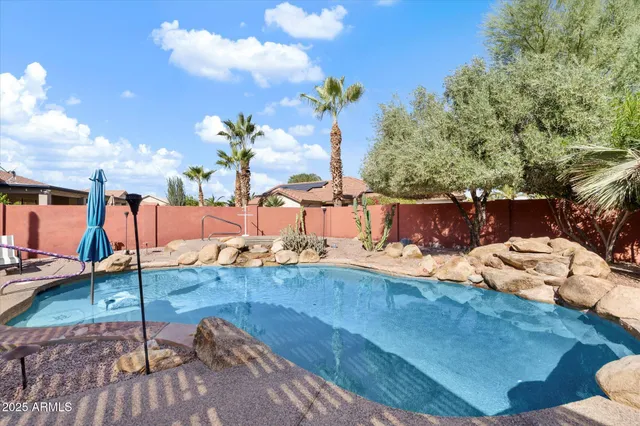 a view of a house with swimming pool and sitting area
