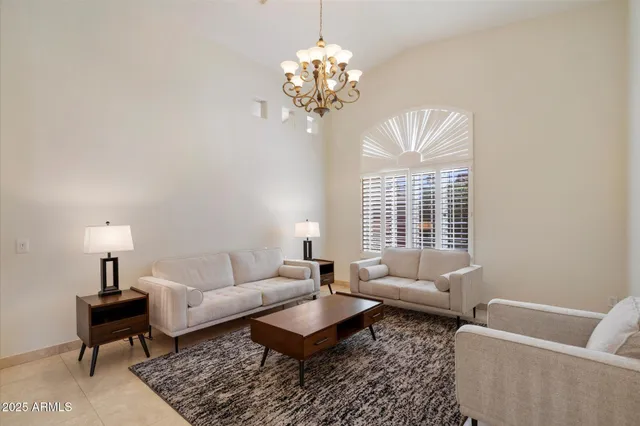 a living room with furniture and a chandelier