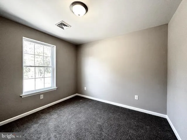 an empty room with closet area