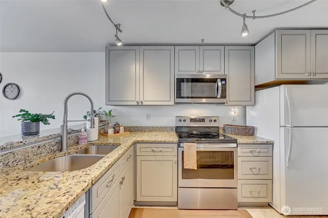 a kitchen with a sink stove and cabinets