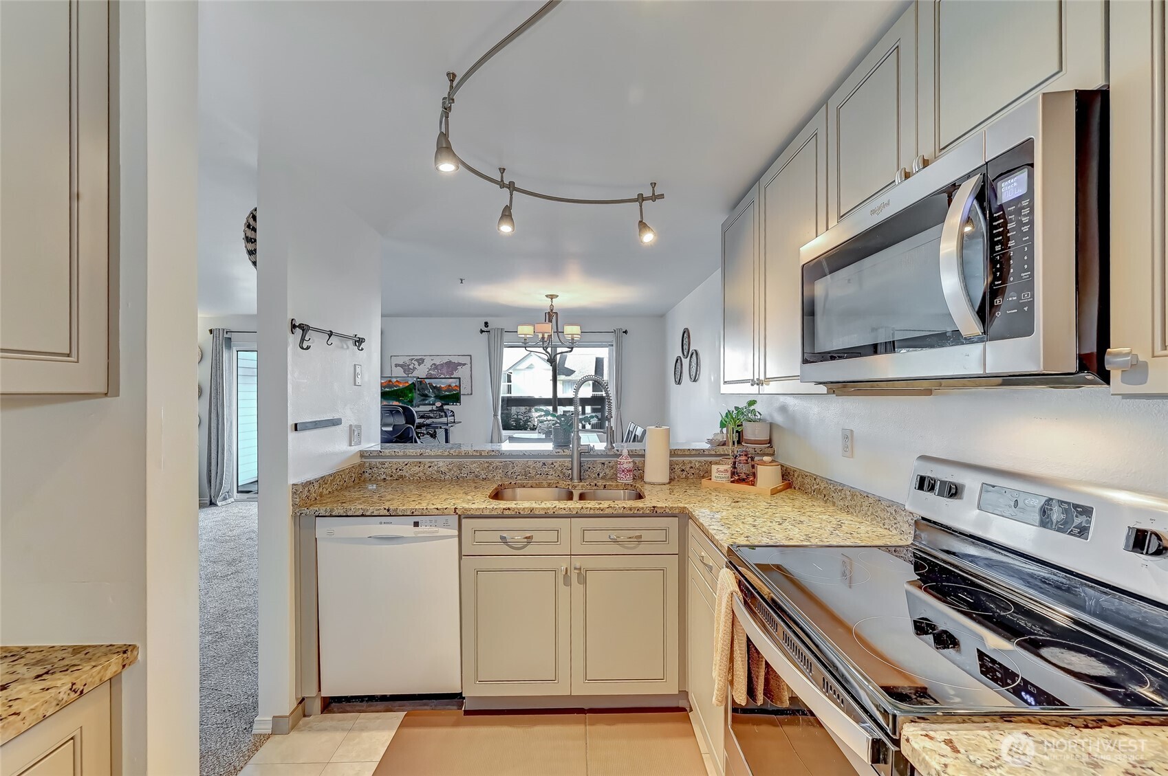 5000 Lake Washington Boulevard Northeast, Unit F105 Renton, WA 98056 - Photo 12 of 27 a kitchen with a sink stove and cabinets