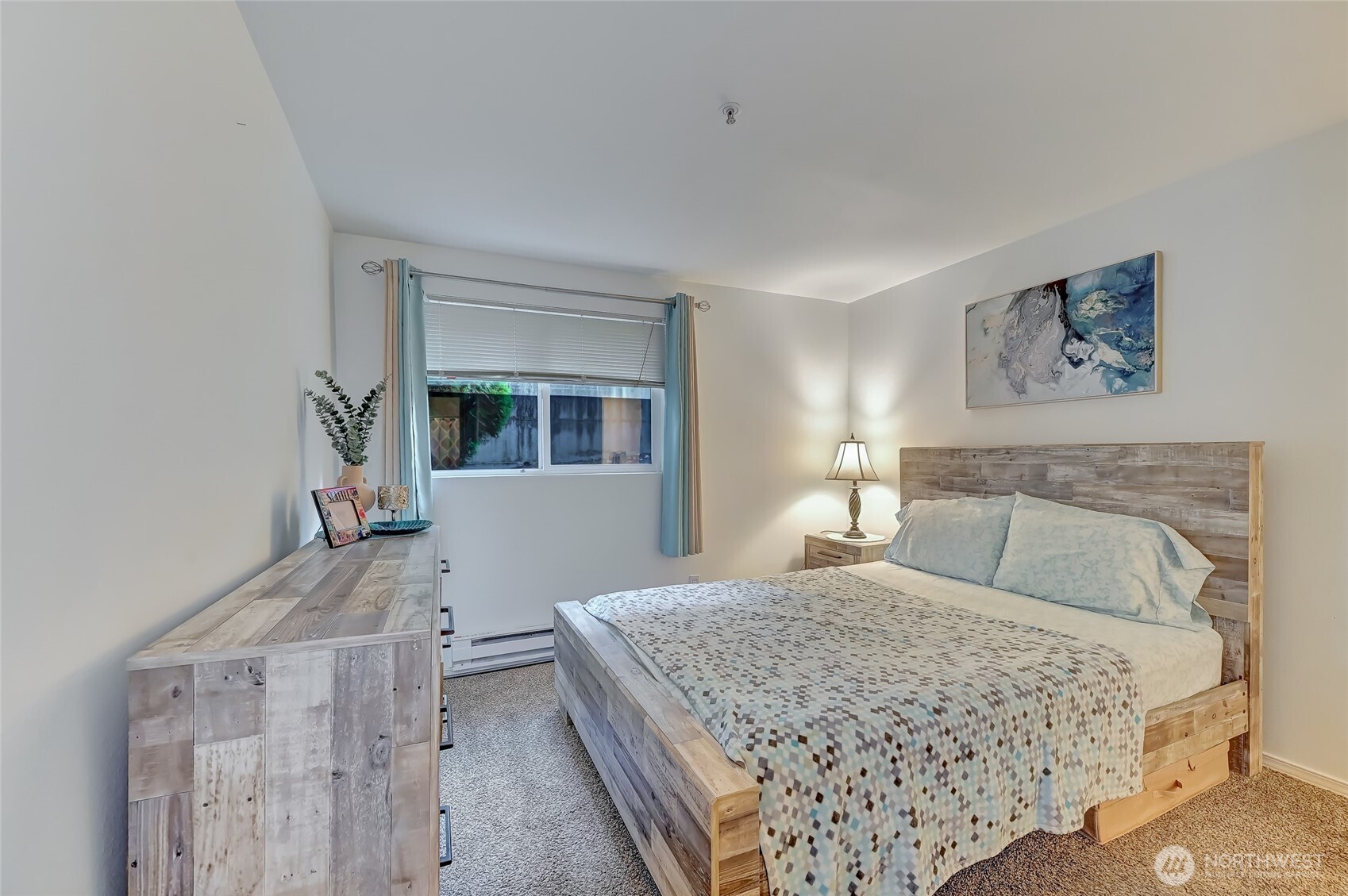 5000 Lake Washington Boulevard Northeast, Unit F105 Renton, WA 98056 - Photo 13 of 27 a bedroom with a large bed and a chandelier