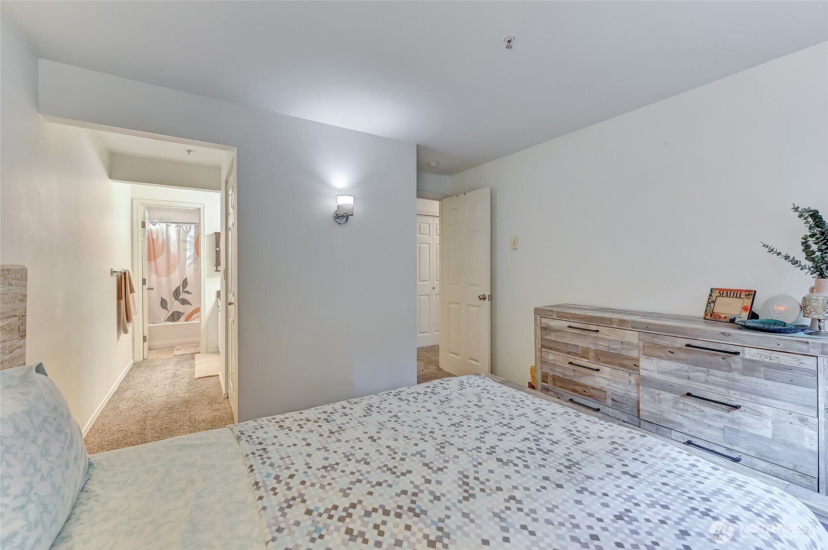 5000 Lake Washington Boulevard Northeast, Unit F105 Renton, WA 98056 - Photo 16 of 27 a bedroom with a bed and cabinets