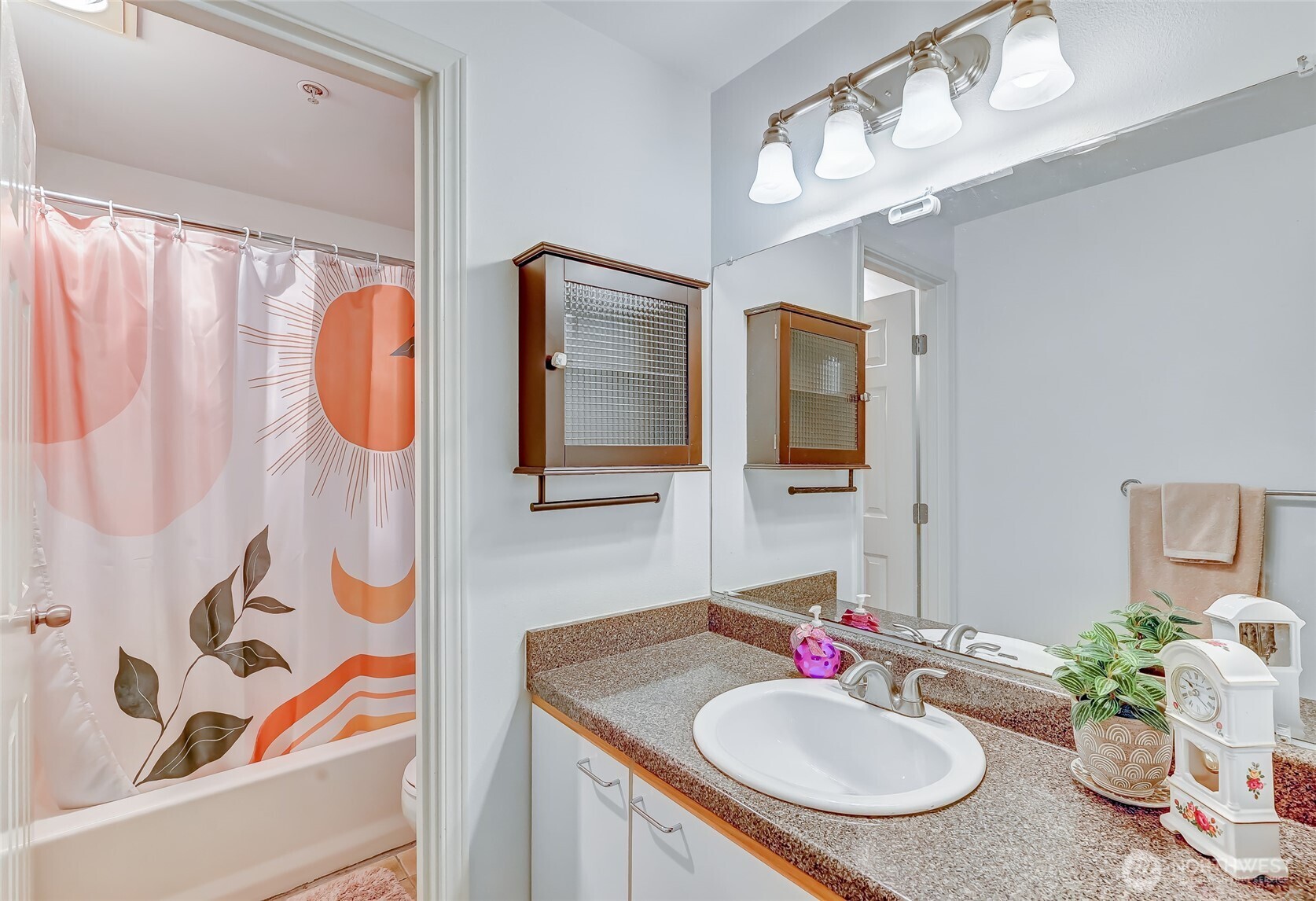 5000 Lake Washington Boulevard Northeast, Unit F105 Renton, WA 98056 - Photo 18 of 27 a bathroom with a sink vanity mirror and tub