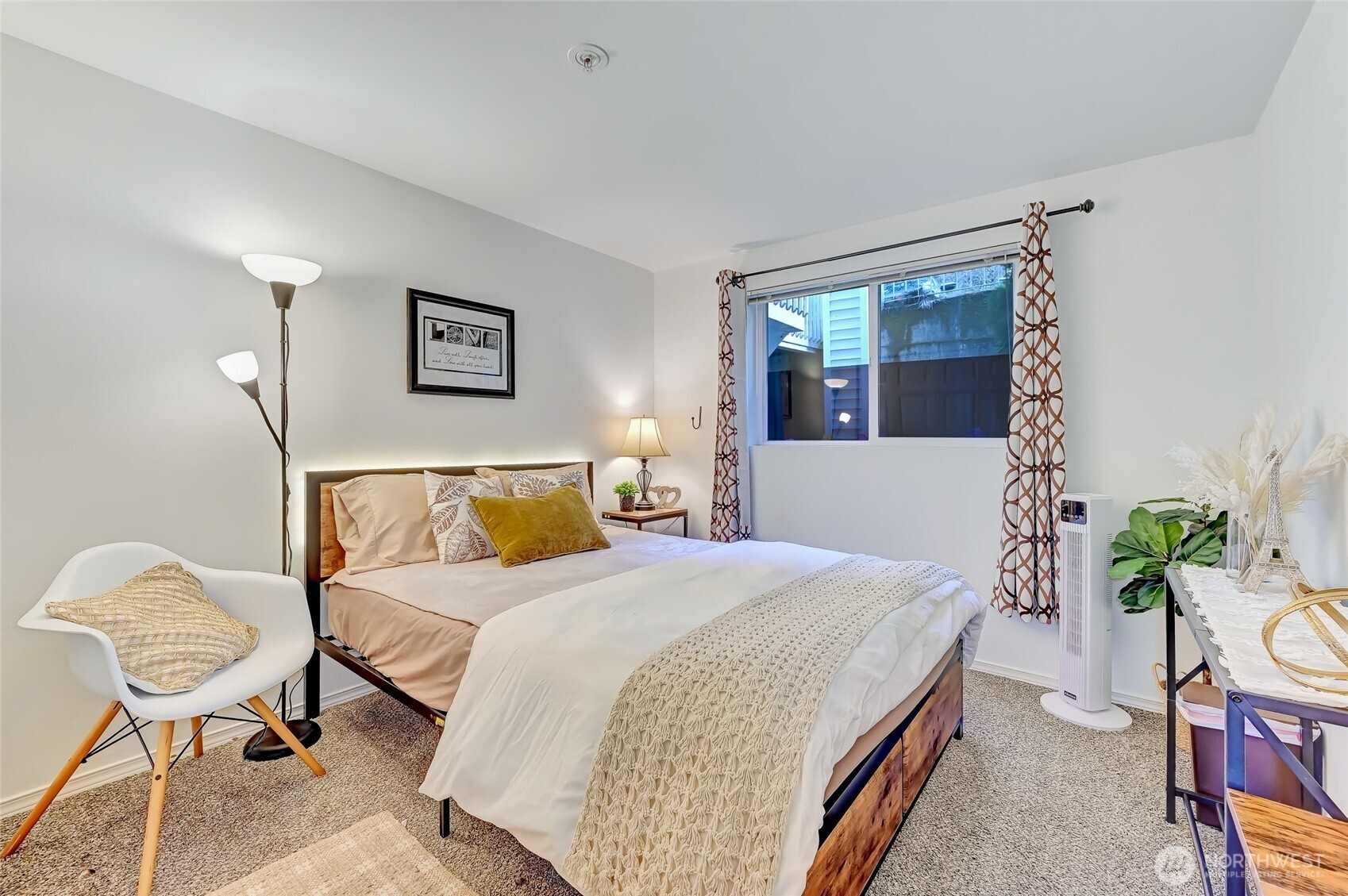 5000 Lake Washington Boulevard Northeast, Unit F105 Renton, WA 98056 - Photo 19 of 27 a bedroom with a bed and potted plant on the dresser