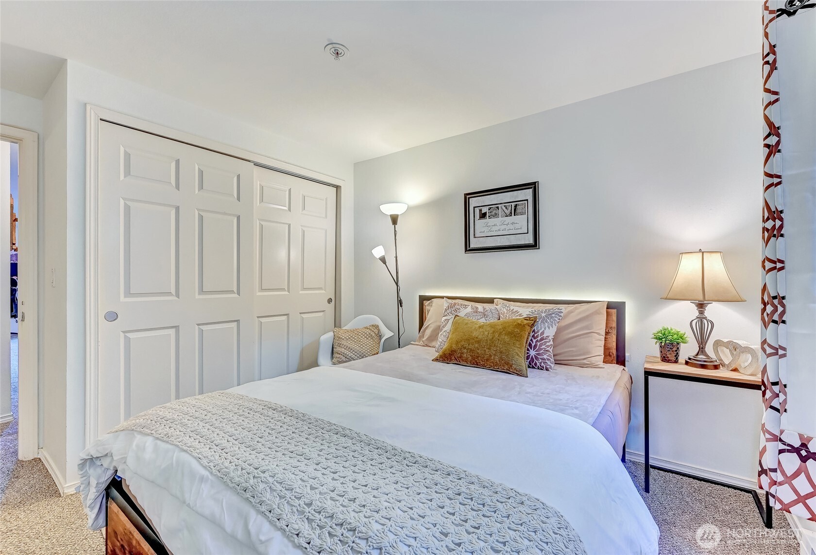 5000 Lake Washington Boulevard Northeast, Unit F105 Renton, WA 98056 - Photo 20 of 27 a bedroom with a bed and painting on the wall