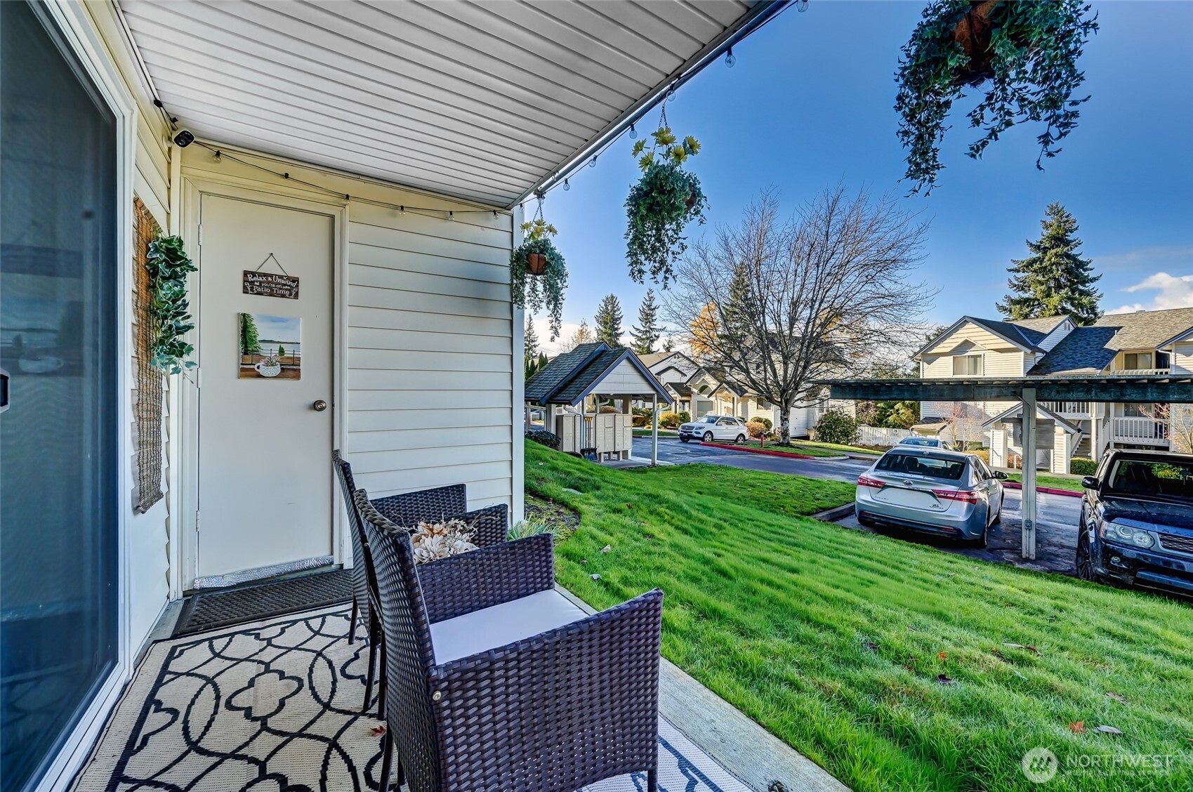 5000 Lake Washington Boulevard Northeast, Unit F105 Renton, WA 98056 - Photo 23 of 27 a view of a patio with couches chairs potted plants and wooden fence