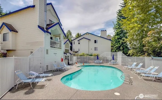 a room with furniture pool table and windows