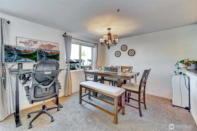 a dining room with a wooden table and chairs