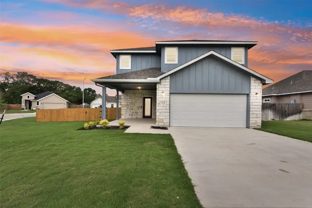 a front view of a house with a yard