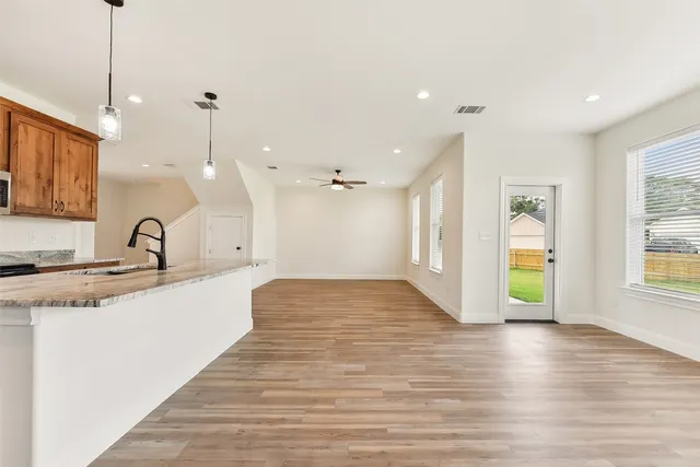 a view of a kitchen with a sink and windows
