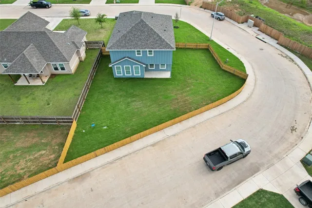 an aerial view of a house with a yard