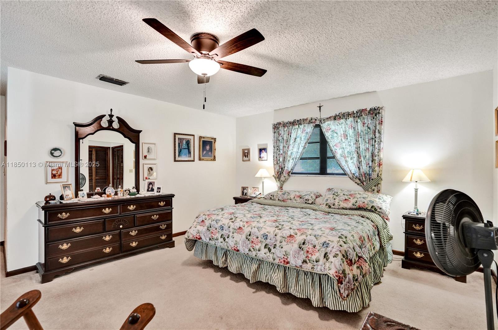 9461 Southwest 134th Street Miami, FL 33176 - Photo 18 of 33 a bedroom with a bed and a chandelier