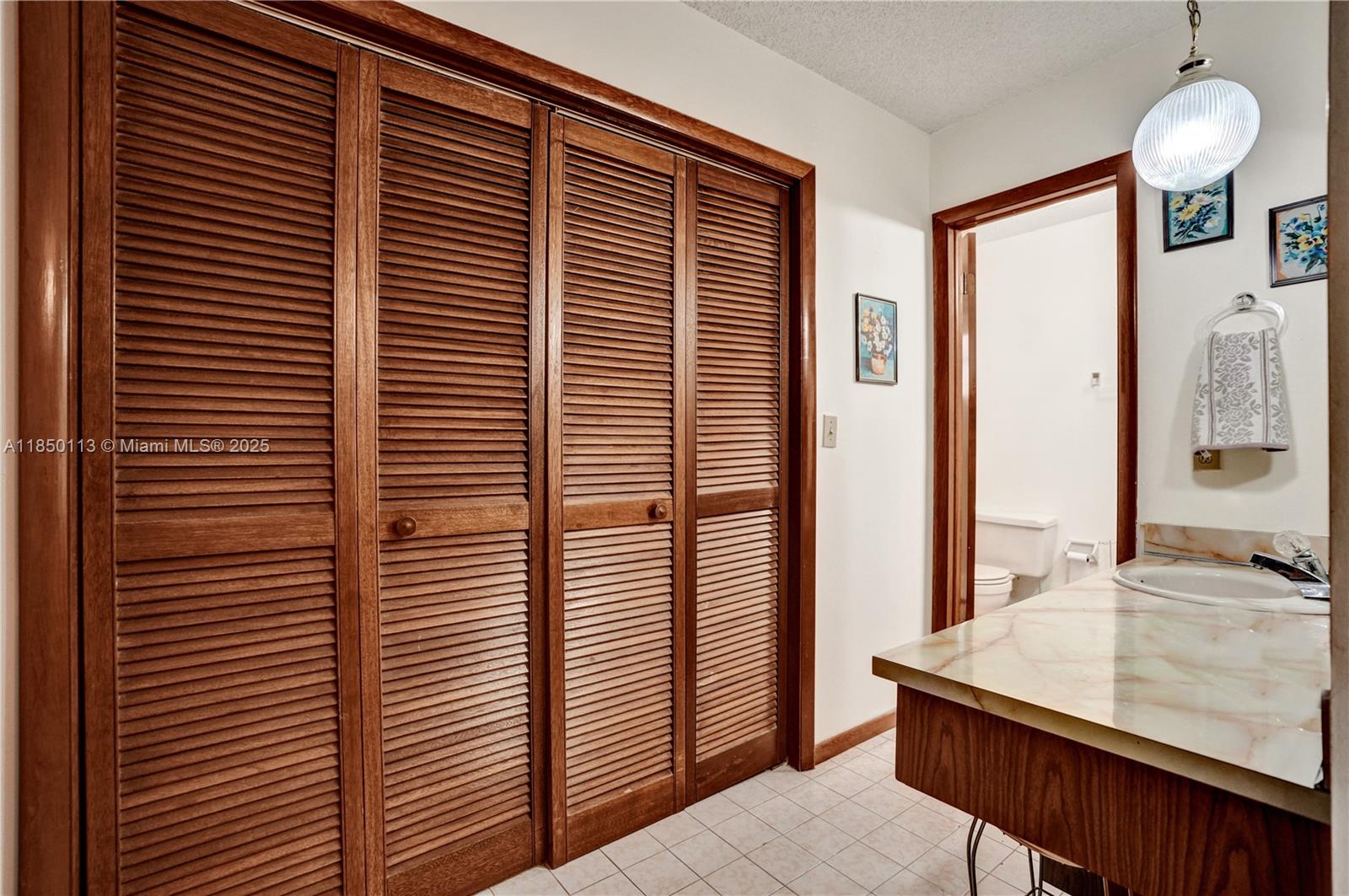 9461 Southwest 134th Street Miami, FL 33176 - Photo 20 of 33 a bathroom with a sink and a mirror