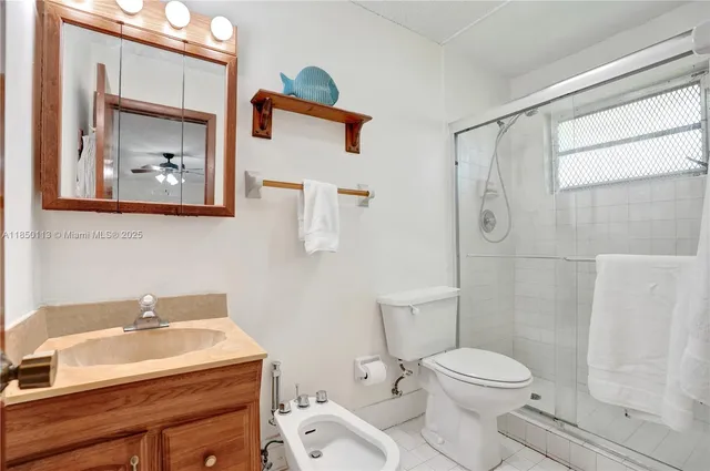 a bathroom with a sink mirror vanity and toilet